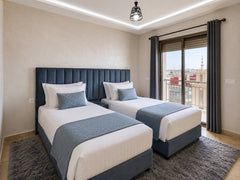Wide view of the twin bedroom with window in the apartment near Agadir Bay.
