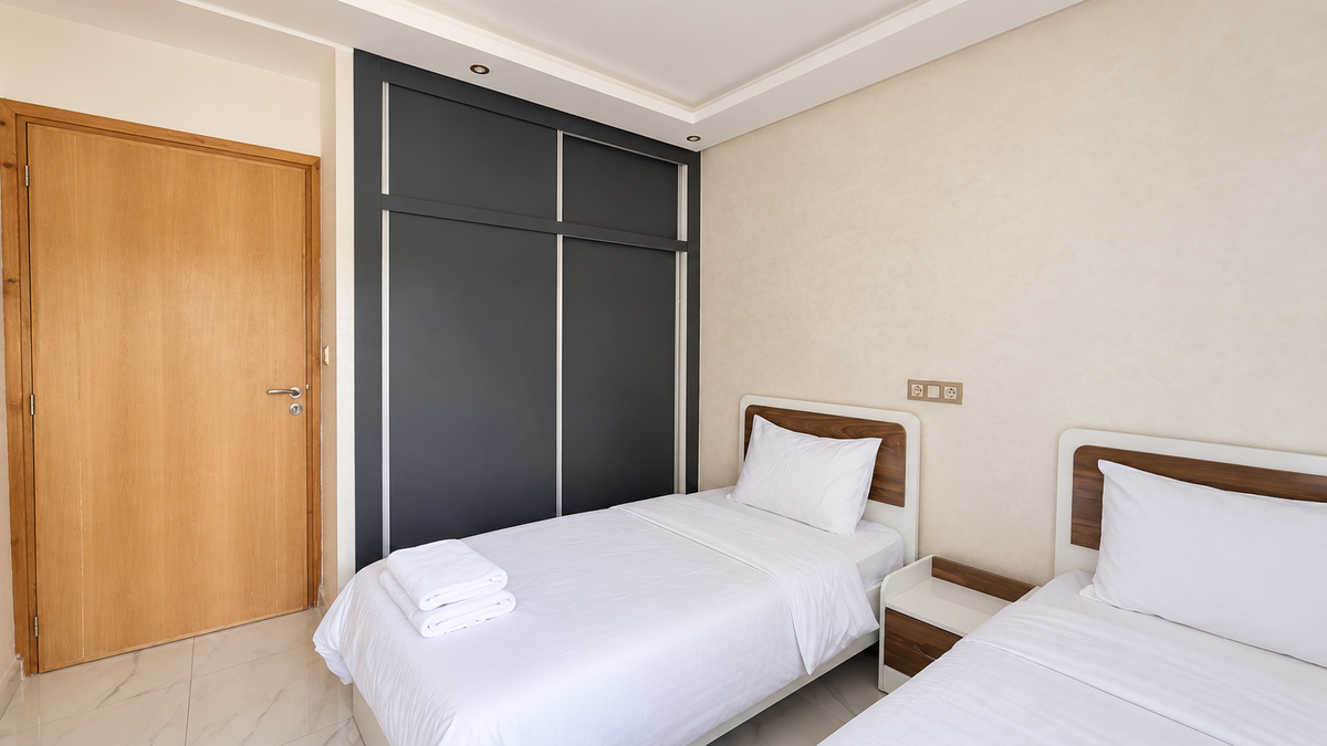 Twin bedroom and wardrobe at the Central Agadir holiday apartment near the beach and souk