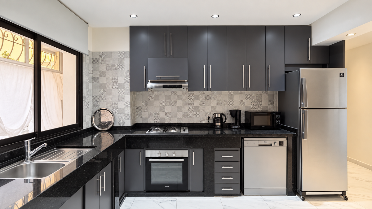 Kitchen with dark cabinets at the Central Agadir holiday apartment near the beach and souk