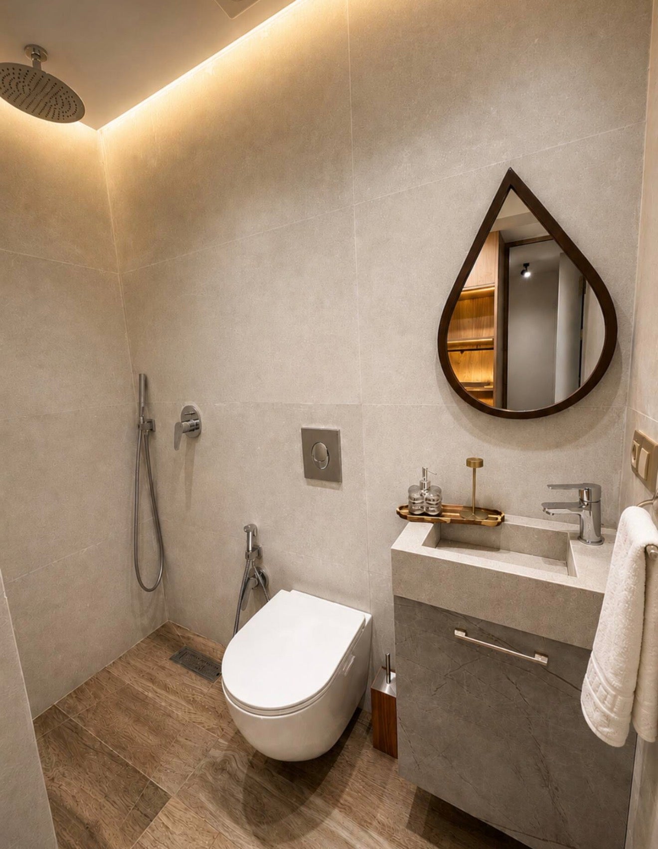 Bathroom vanity in DHAJIA Tilila, Agadir apartment with mirror, sink and warm modern interior styling.