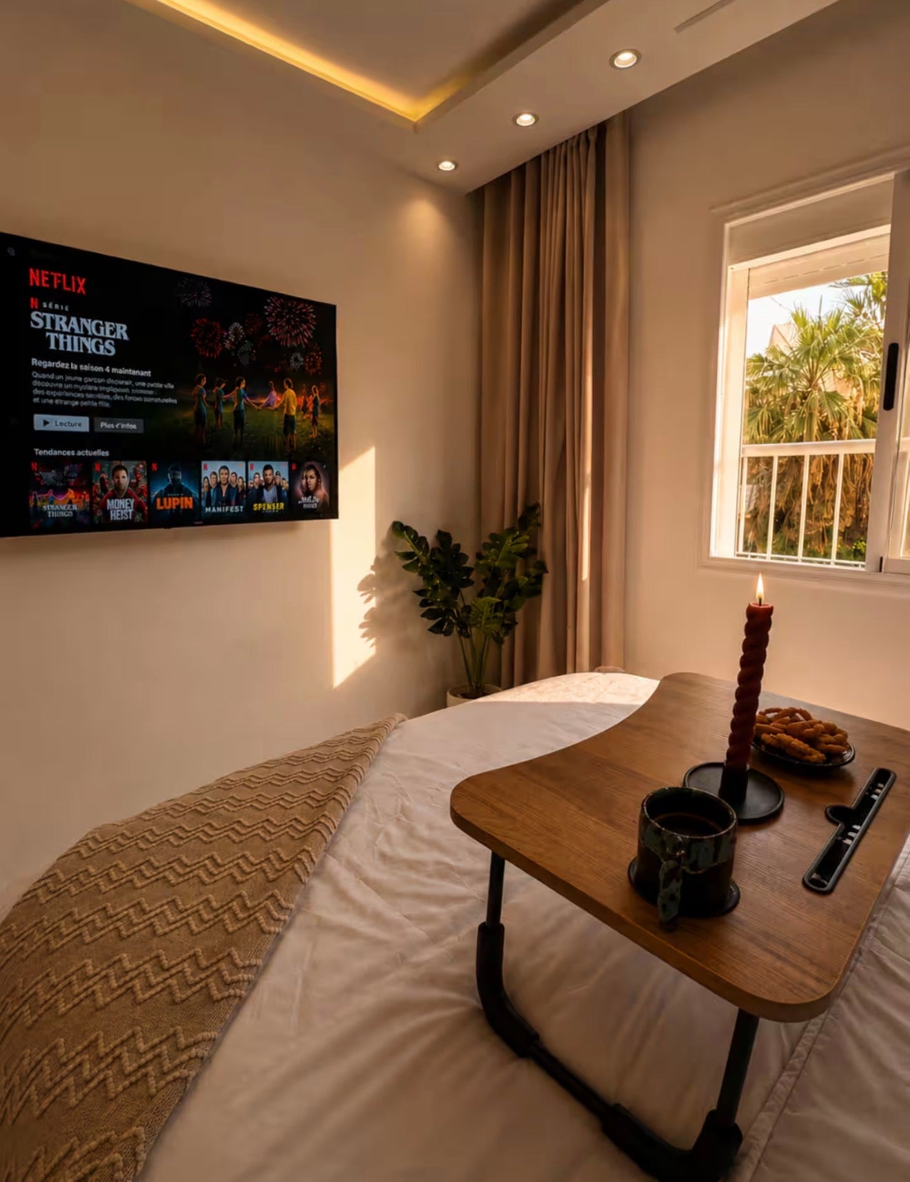 Bedroom with Smart TV in DHAJIA Tilila, Agadir apartment designed for comfortable stay-in evenings.