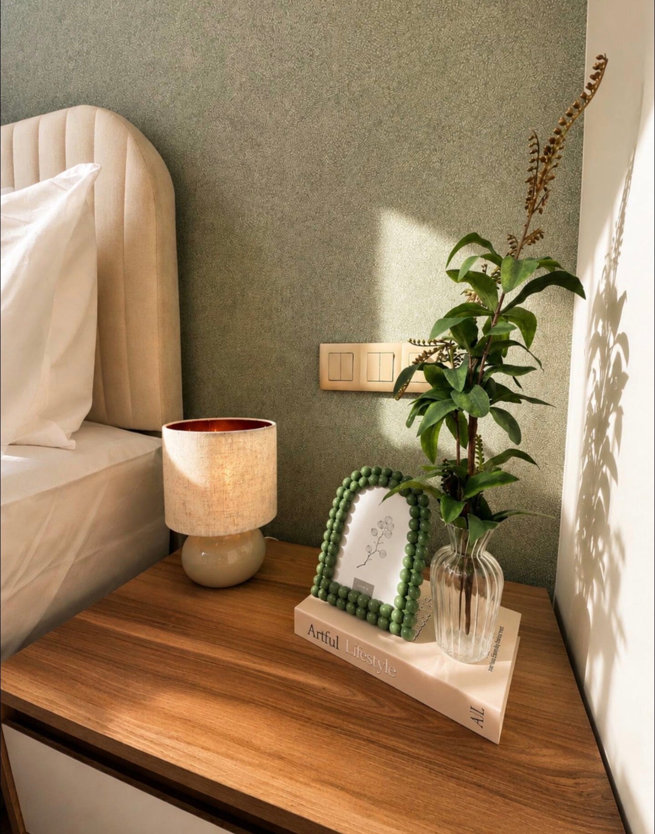 Bedside detail in DHAJIA Tilila, Agadir apartment with soft lighting and calm interior styling.