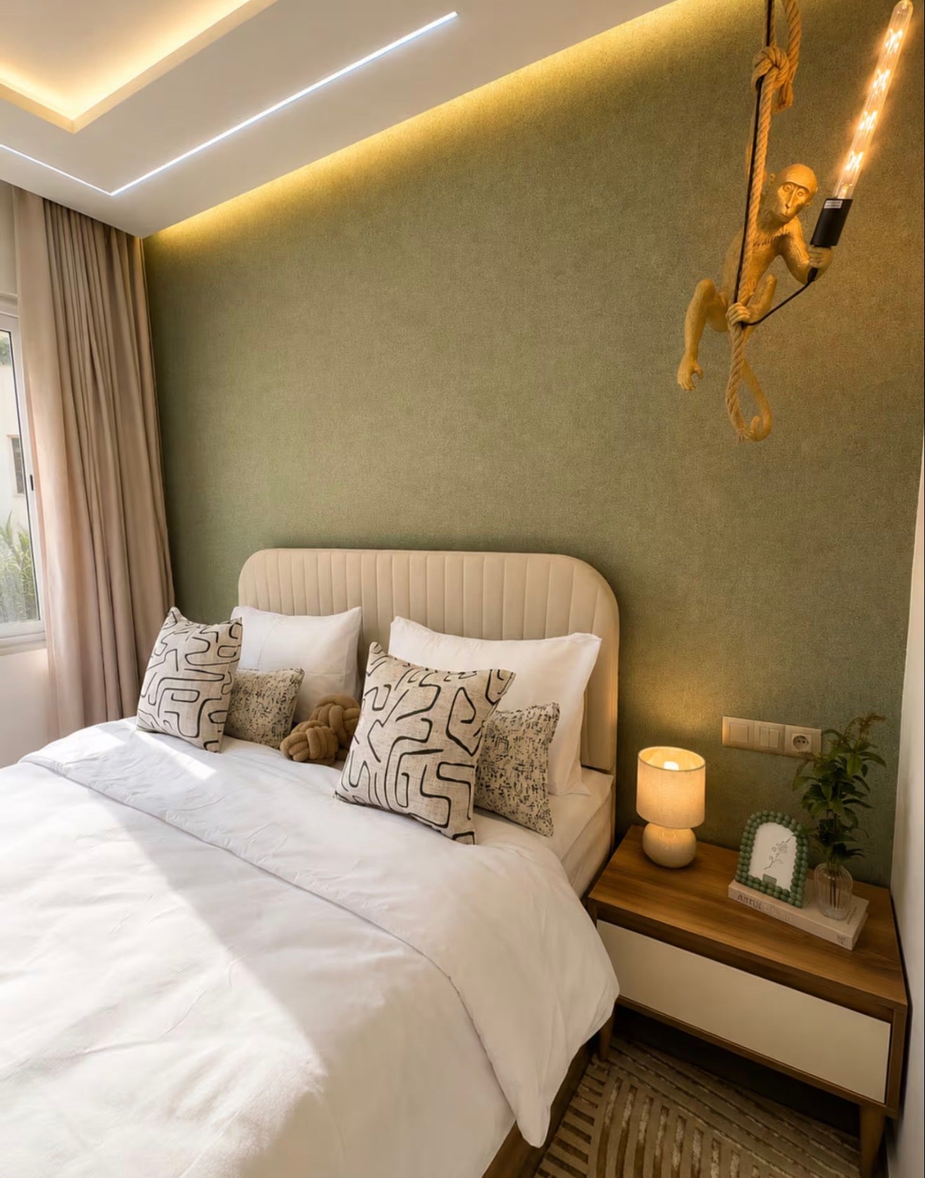 Double bedroom in DHAJIA Tilila, Agadir apartment with warm tones, soft bedding and modern styling.