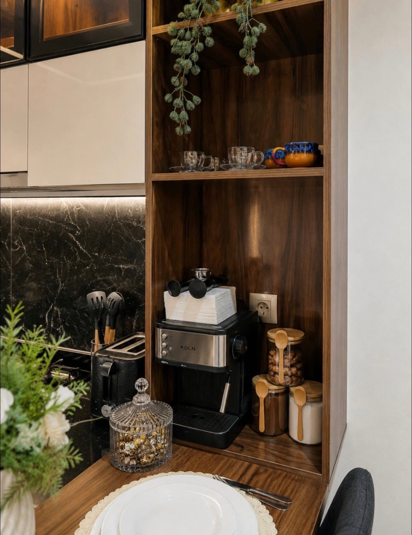Kitchen shelving and storage in DHAJIA Tilila, Agadir apartment with warm wood details and practical setup.