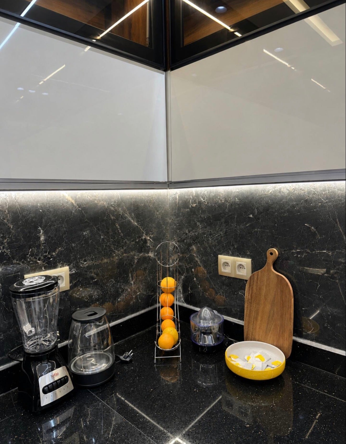 Kitchen worktop in DHAJIA Tilila, Agadir apartment with modern black finish and guest essentials.