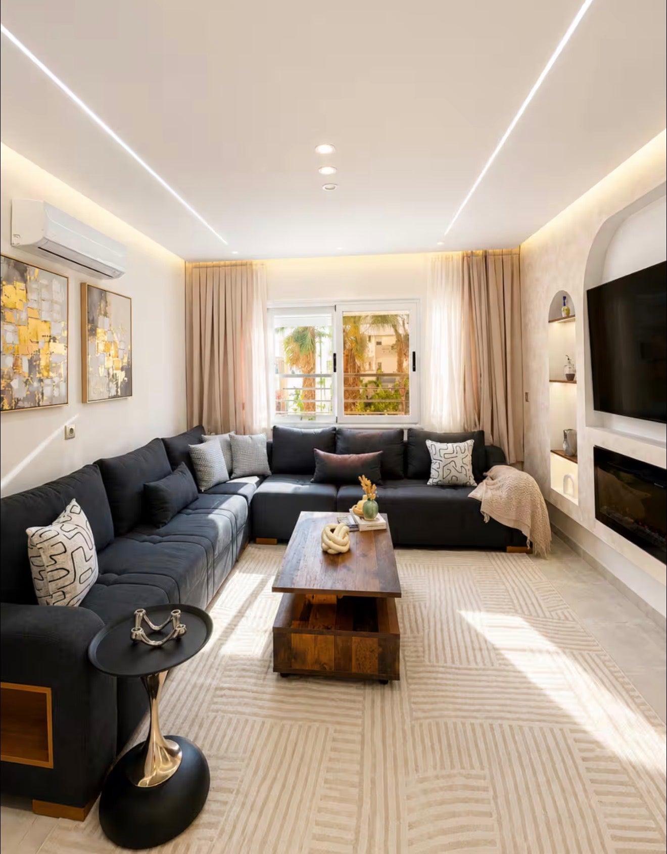 Living and dining space in DHAJIA Tilila, Agadir apartment with soft seating, warm lighting and modern finish.