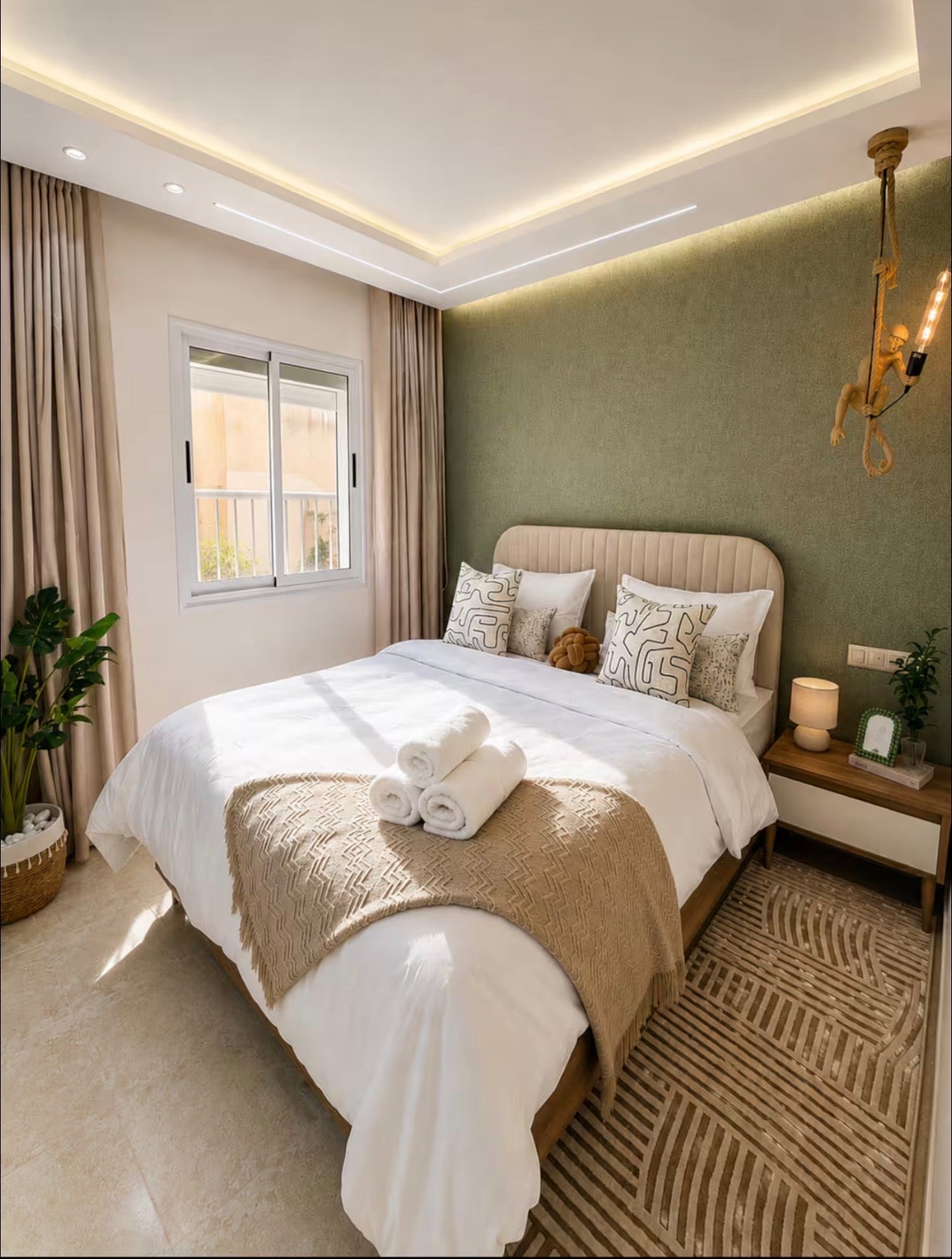 Main bedroom in DHAJIA Tilila, Agadir apartment with comfortable bed, soft lighting and modern décor.