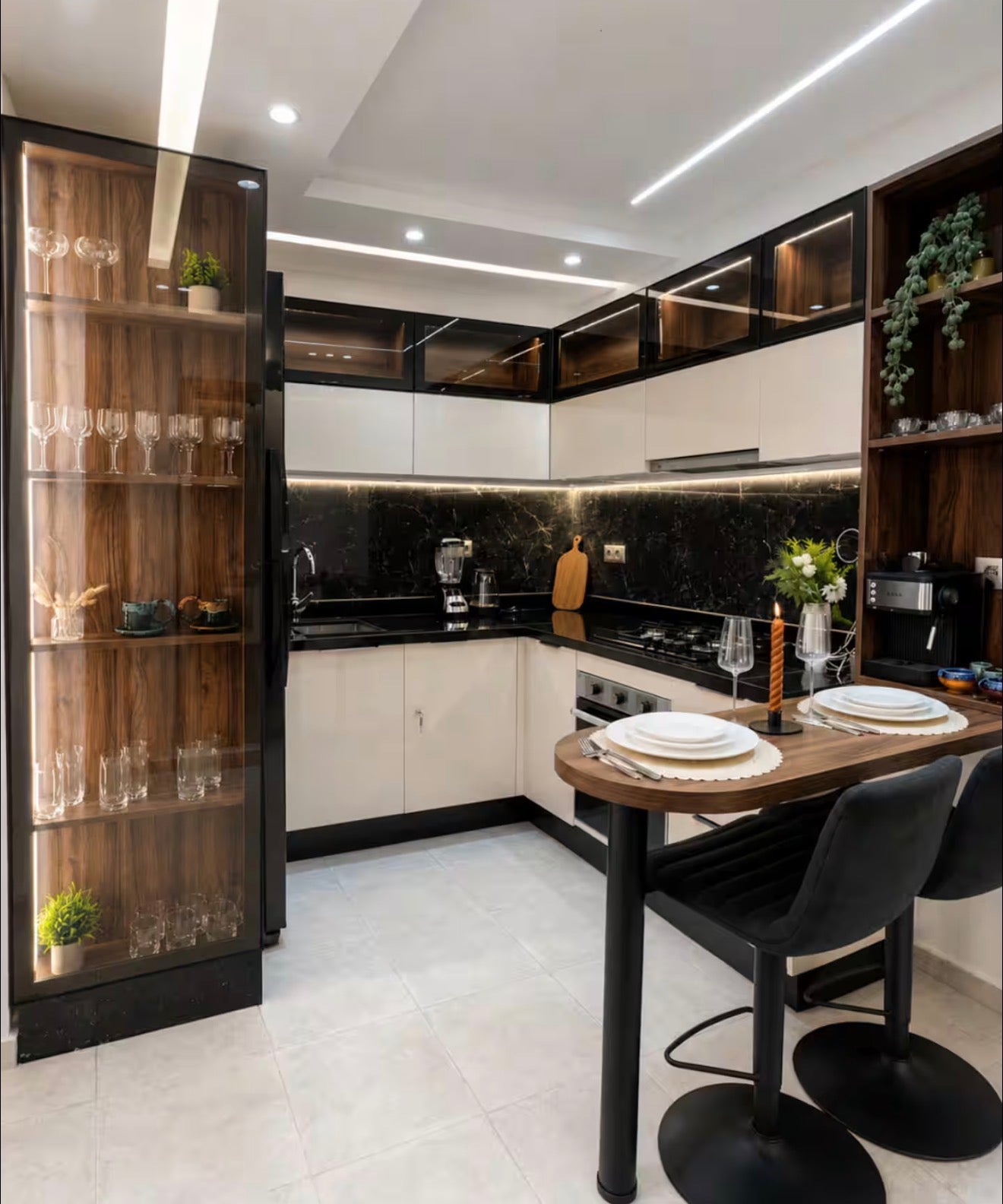Modern kitchen in DHAJIA Tilila, Agadir apartment with fitted cabinets, dining space and warm lighting.