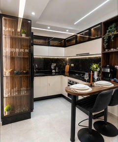 Modern kitchen in DHAJIA Tilila, Agadir apartment with fitted cabinets, dining space and warm lighting.