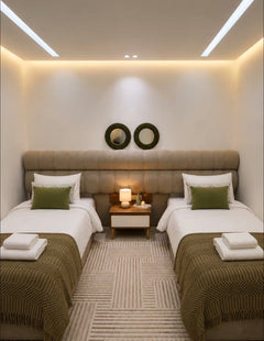 Twin bedroom in DHAJIA Tilila, Agadir apartment with soft bedding, warm lighting and modern décor.
