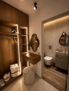 Walk-in wardrobe and dressing storage area in DHAJIA Tilila, Agadir apartment with warm lighting and modern bathroom access.