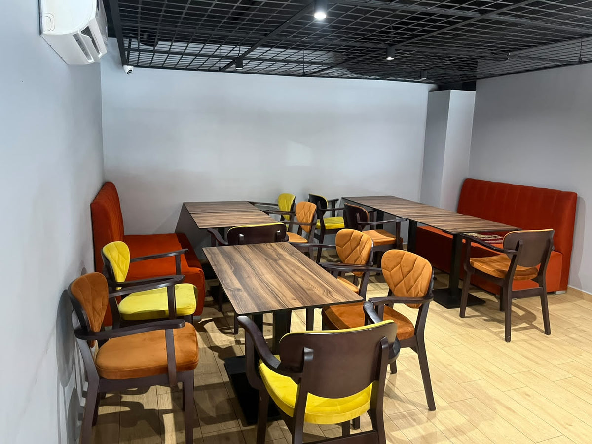 Peri Peri Grill dining area with colourful chairs and orange booth seating, Agadir Bay