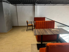 Orange booth seating beside the glass balustrade at Peri Peri Grill, Agadir Bay