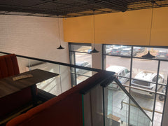 Upper-level dining area overlooking the restaurant frontage at Peri Peri Grill