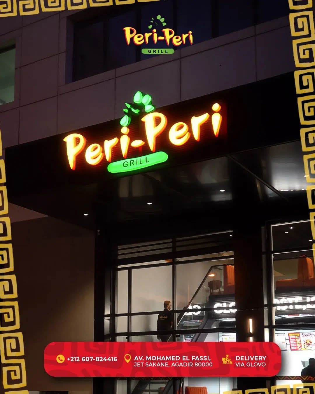 Peri Peri Grill illuminated exterior signage in Agadir Bay at night