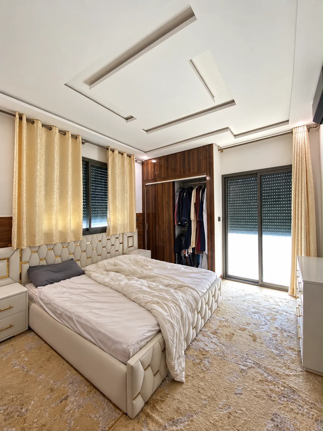 Double bedroom with upholstered bed and large window in the presidential apartment, Agadir