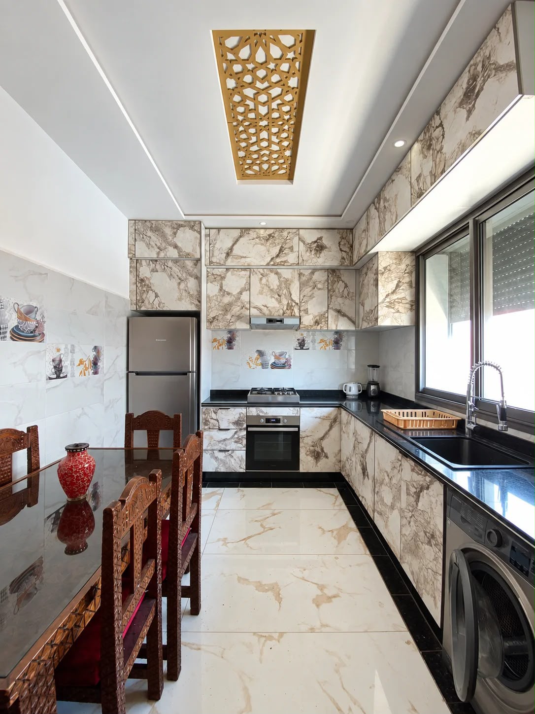 Fitted kitchen with oven refrigerator washing machine and dining table in the presidential apartment, Agadir