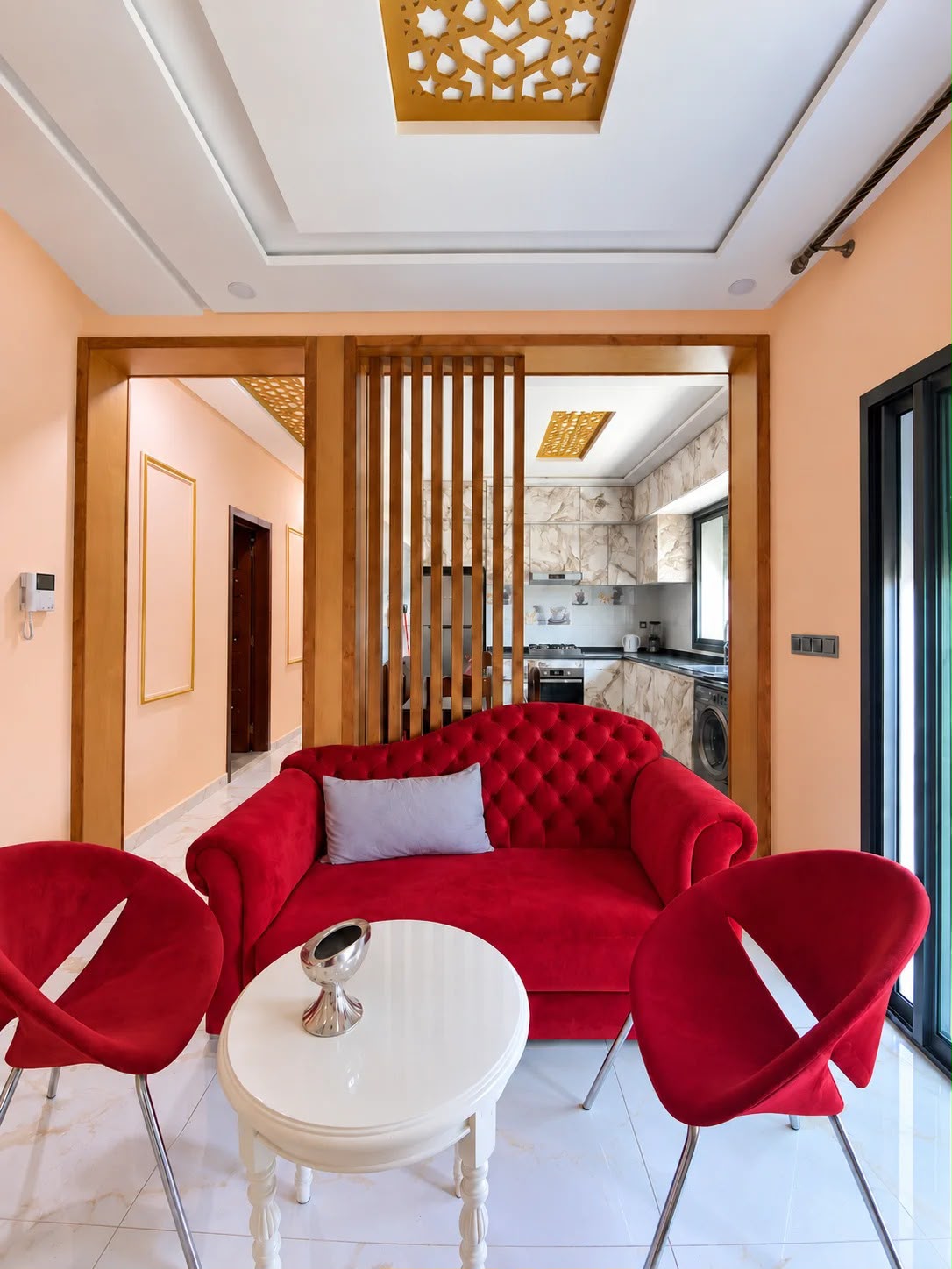 Red-accented sitting area beside the fitted kitchen in the presidential apartment, Agadir