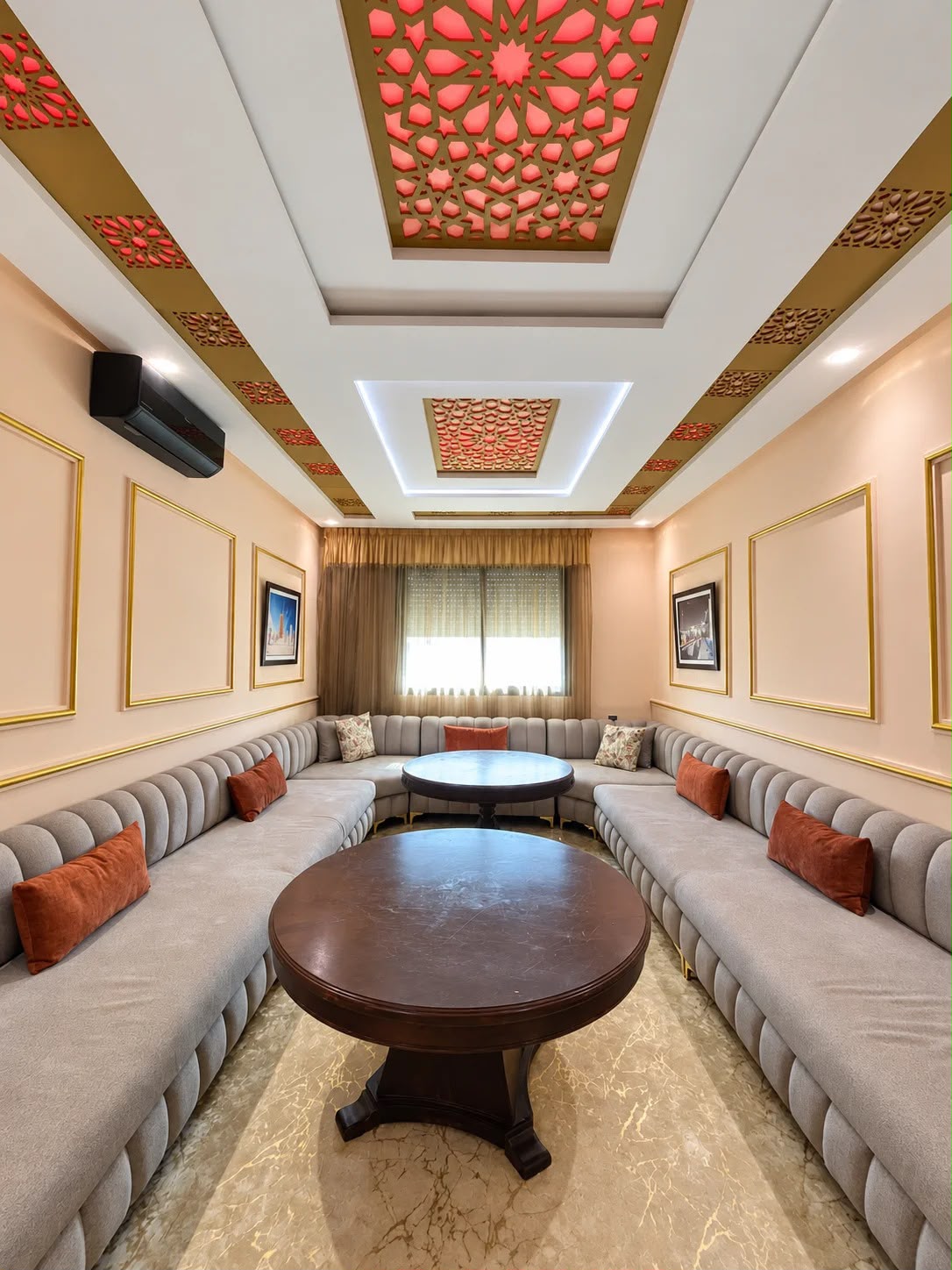 Wide view of Moroccan salon with long sofas and illuminated ceiling in the presidential apartment, Agadir